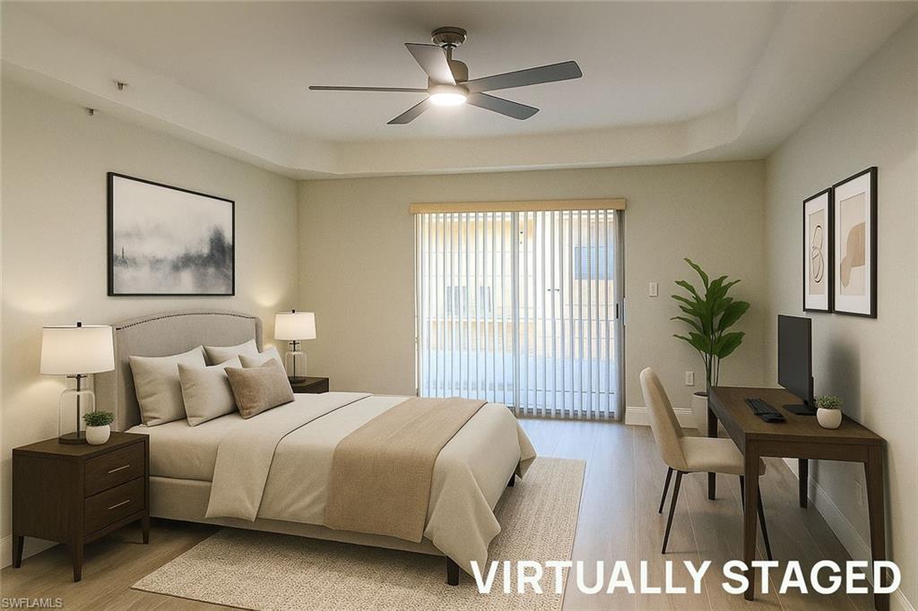 1100 Pine Ridge Road, Unit A106 Naples, FL 34108 - Photo 8 of 27 a bedroom with a bed and a chandelier