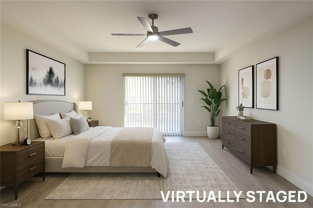 1100 Pine Ridge Road, Unit A106 Naples, FL 34108 - Photo 9 of 27 a bedroom with a large bed and a couch