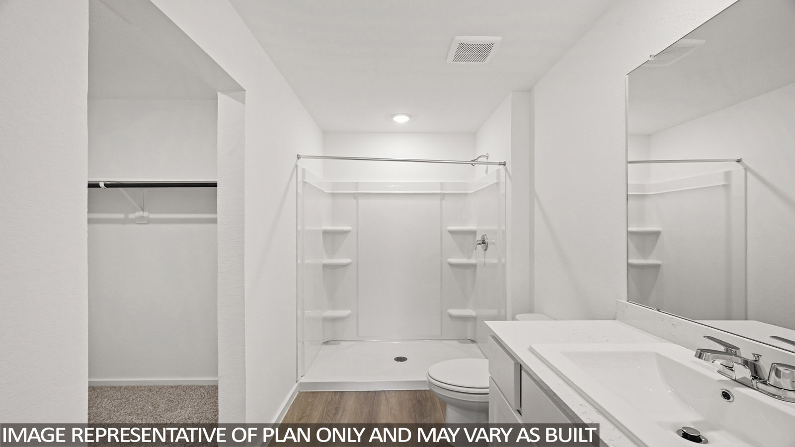 152 Baby Calf Roping Road Jarrell, TX 76537 - Photo 15 of 23 Bathroom featuring a vanity with a white countertop and integrated sink, a large wall-mounted mirror, a shower-tub combination with built-in shelving, and wood-finish flooring