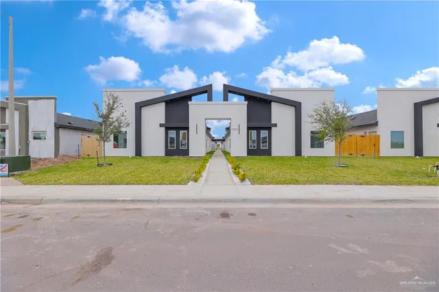 a view of a house with a swimming pool and a yard