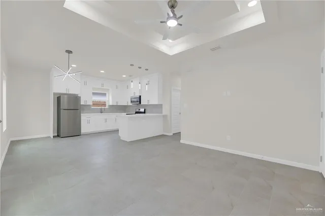 a view of a kitchen with refrigerator and a sink