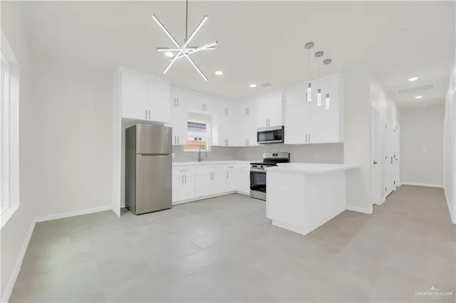 a kitchen with white cabinets and white appliances