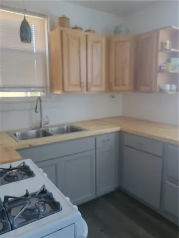 a kitchen with a sink stove and cabinets