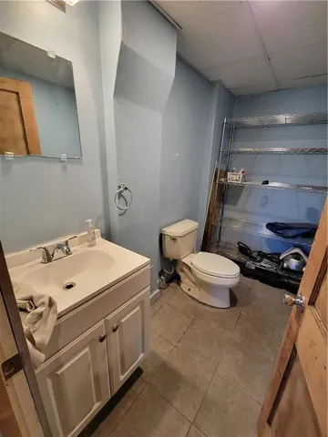 a bathroom with a sink mirror vanity and toilet