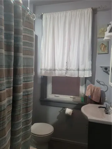 a bathroom with a toilet a sink and a shower