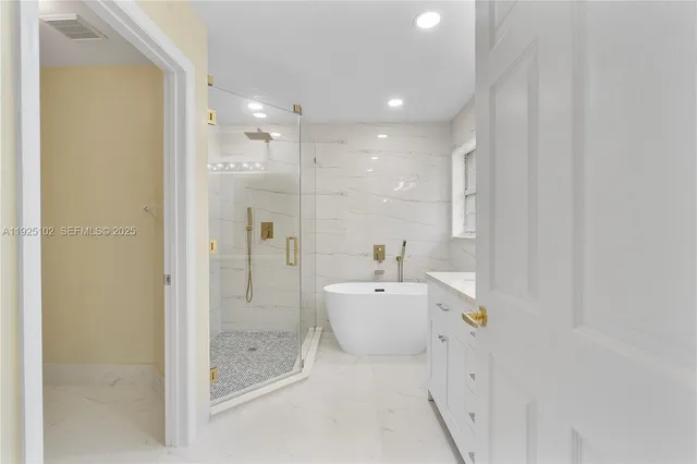 a bathroom with a bathtub shower and toilet