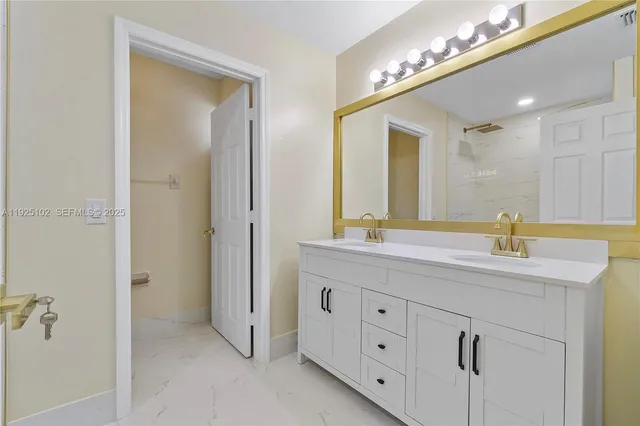 a bathroom with a double vanity sink and a mirror