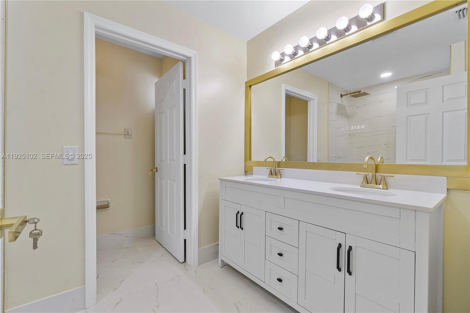 5310 Northwest 124th Way Coral Springs, FL 33076 - Photo 13 of 30 a bathroom with a double vanity sink and a mirror