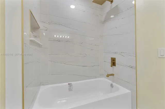 a white bath tub sitting in a bathroom