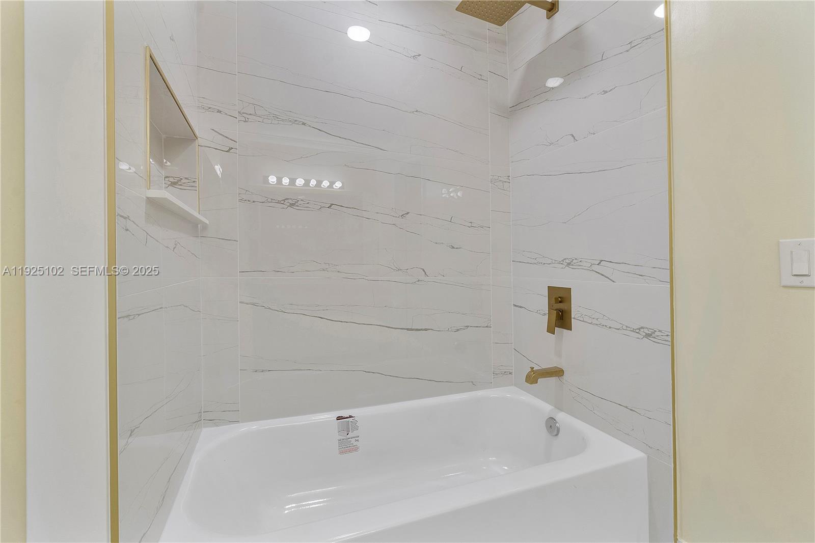 5310 Northwest 124th Way Coral Springs, FL 33076 - Photo 15 of 30 a white bath tub sitting in a bathroom