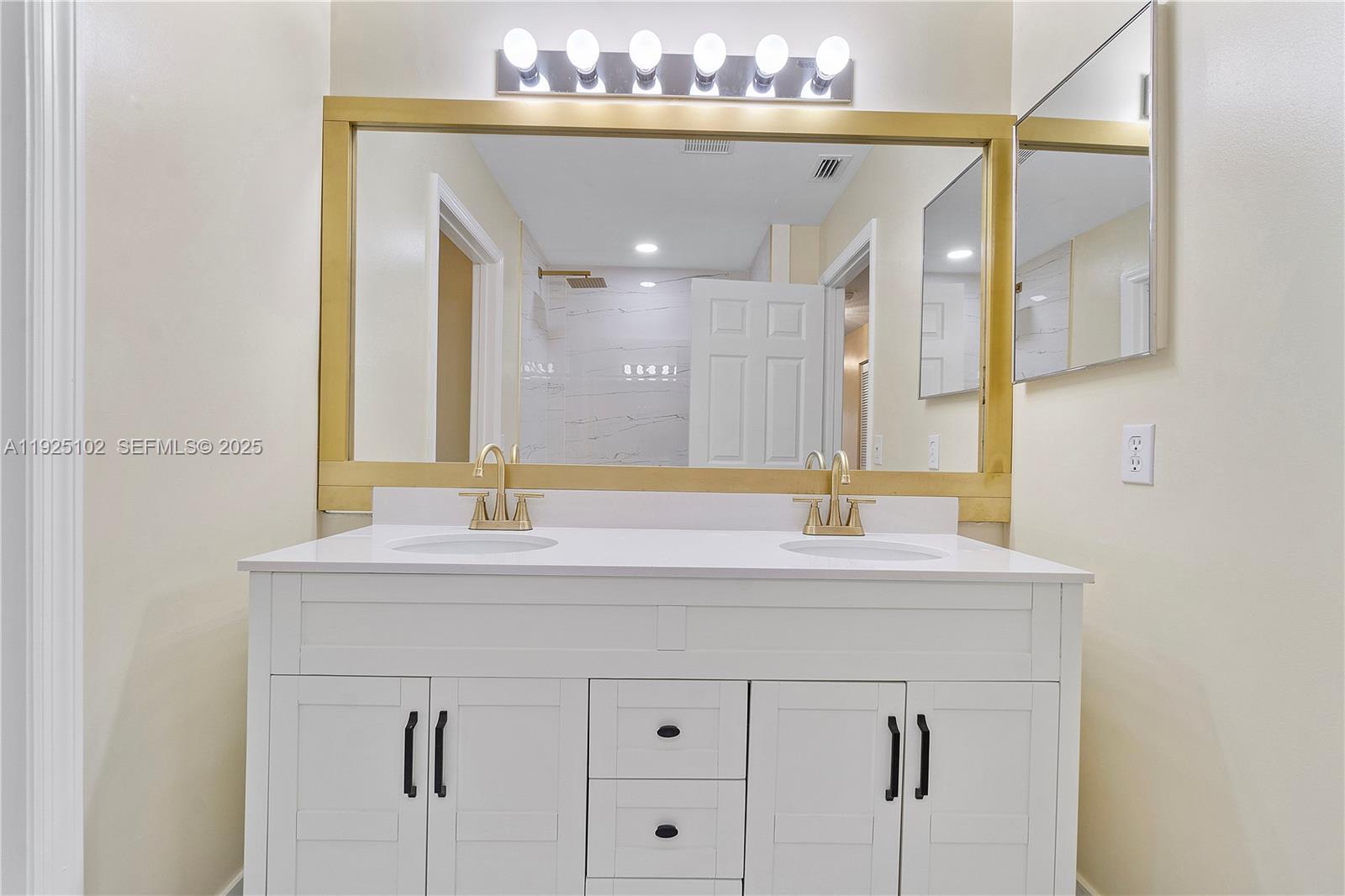 5310 Northwest 124th Way Coral Springs, FL 33076 - Photo 16 of 30 a bathroom with a sink and a mirror