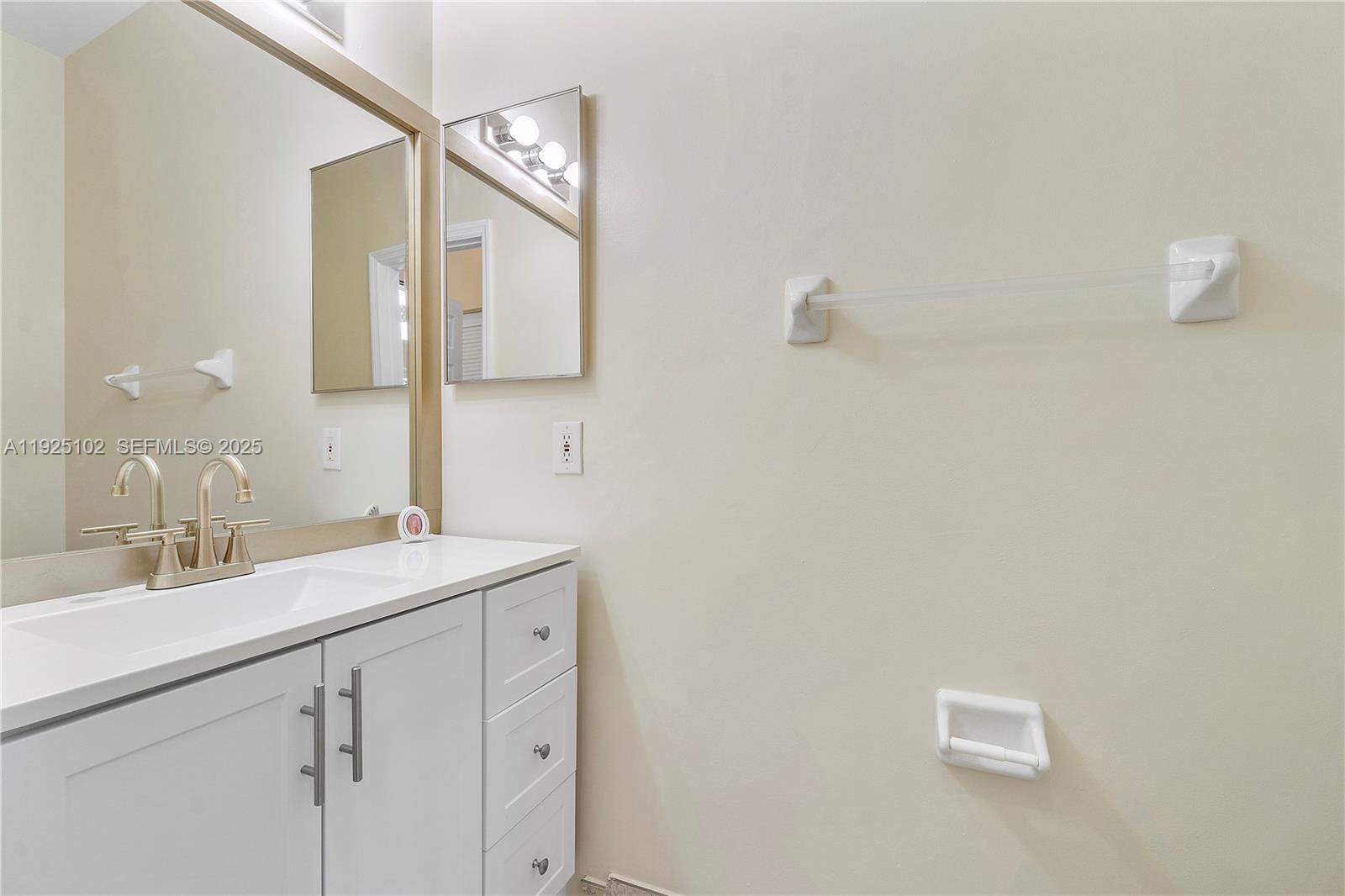 5310 Northwest 124th Way Coral Springs, FL 33076 - Photo 17 of 30 a bathroom with a sink and a mirror