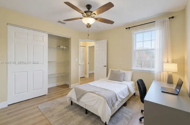 a spacious bedroom with a bed and a table in it