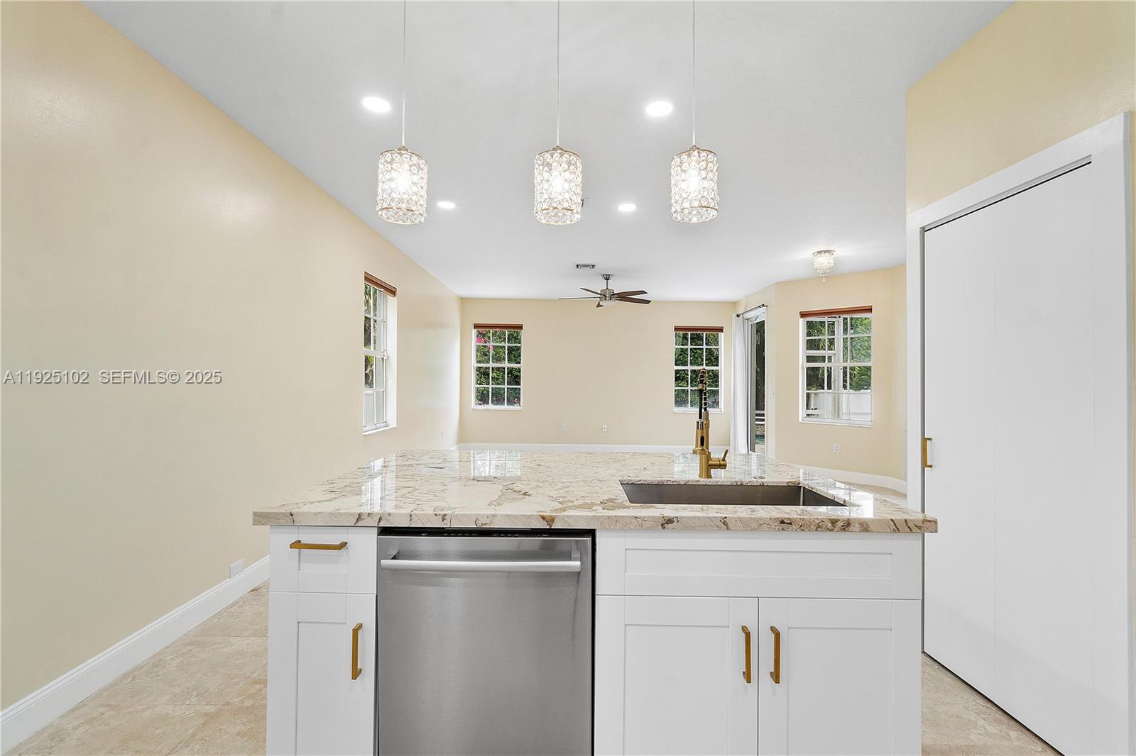 5310 Northwest 124th Way Coral Springs, FL 33076 - Photo 2 of 30 a kitchen with granite countertop cabinets sink and window
