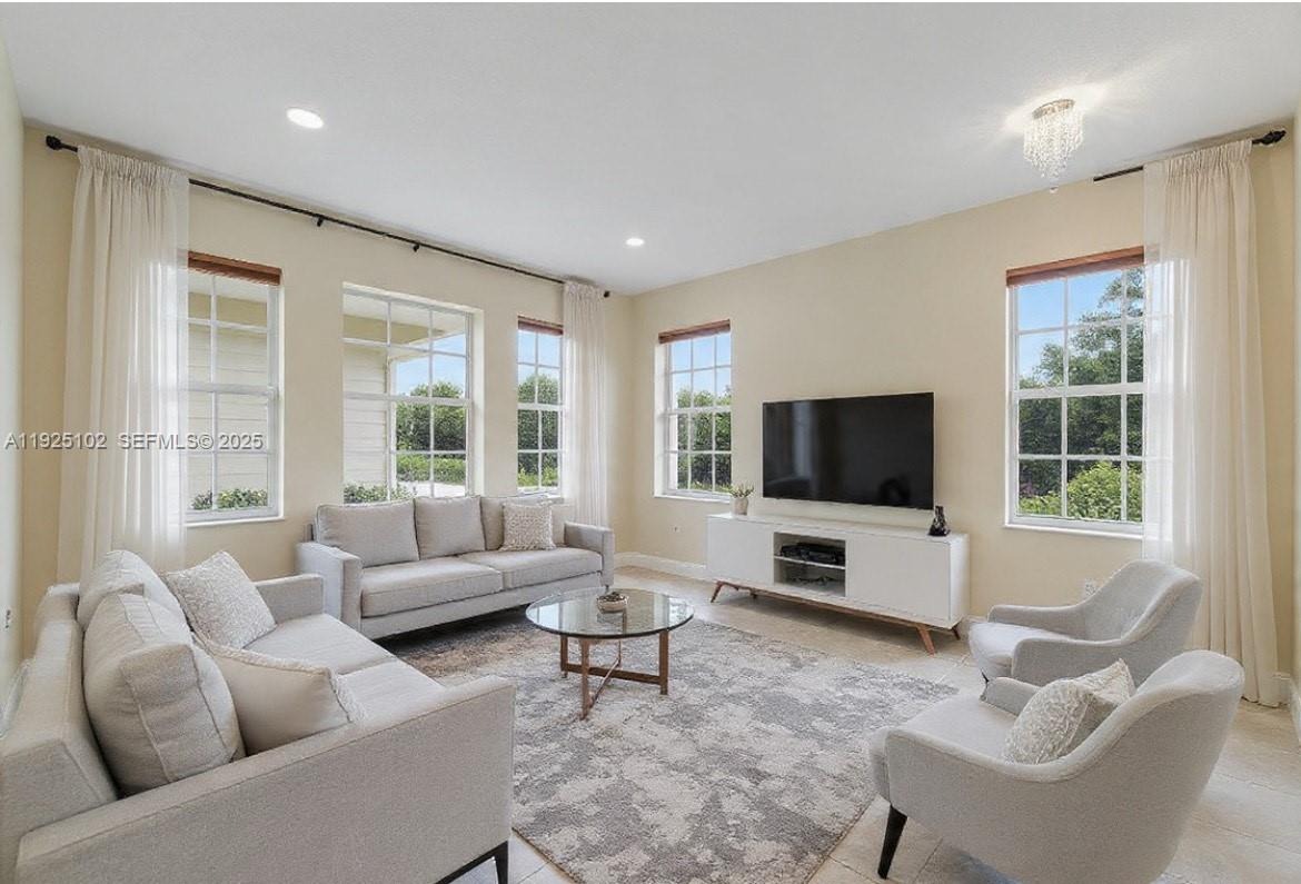 5310 Northwest 124th Way Coral Springs, FL 33076 - Photo 6 of 30 a living room with furniture and a flat screen tv