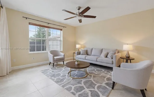 a living room with furniture and a large window