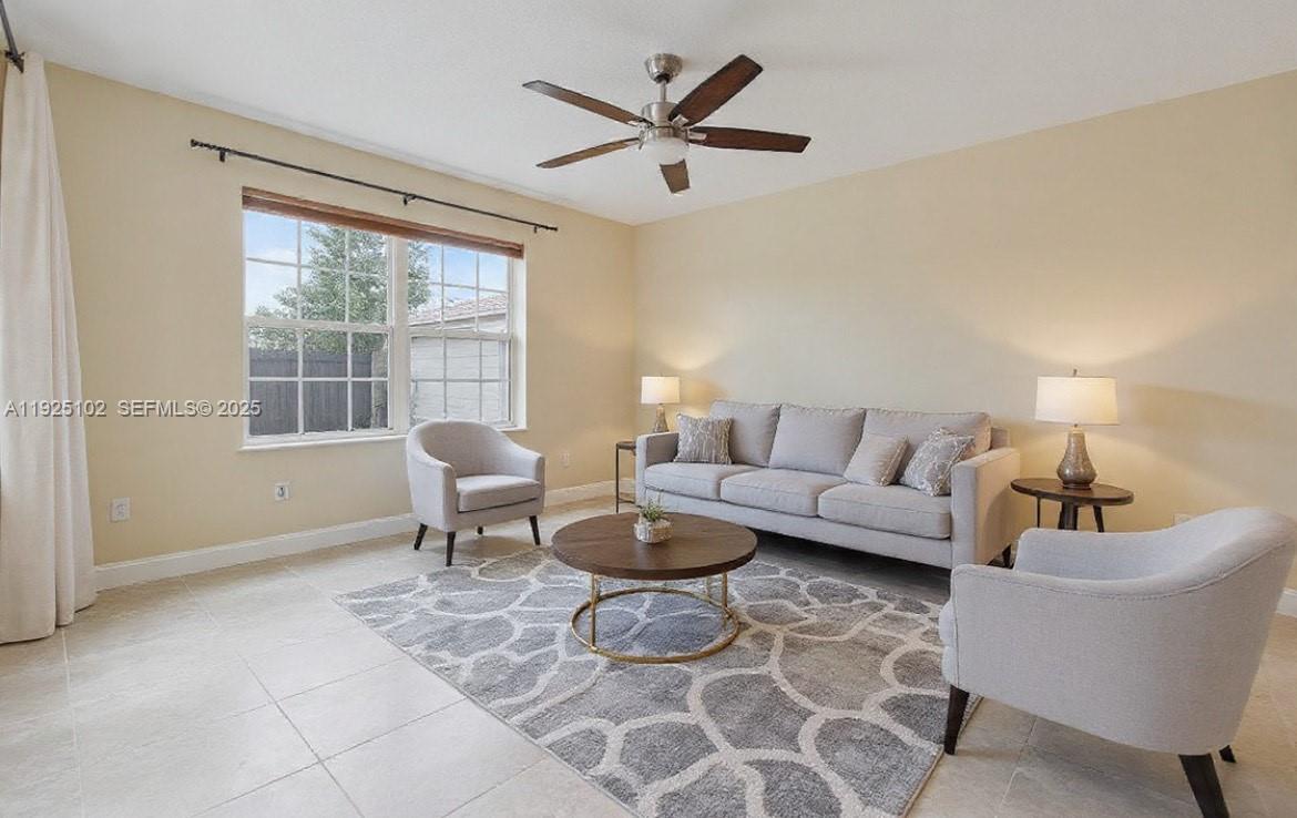 5310 Northwest 124th Way Coral Springs, FL 33076 - Photo 7 of 30 a living room with furniture and a large window