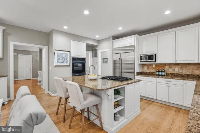 a kitchen with a stove a refrigerator and dining table