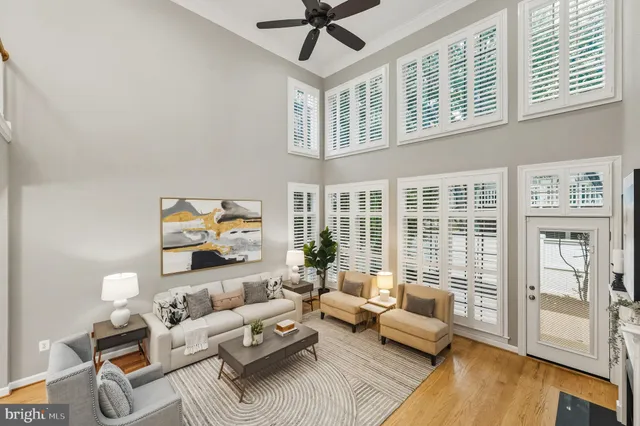 a living room with furniture large window and a table