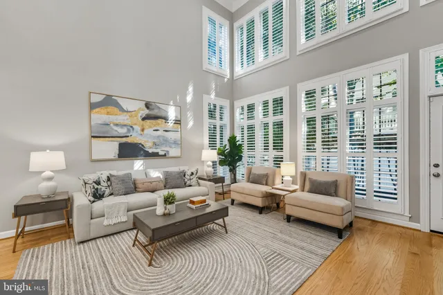 a living room with furniture large window and a fireplace