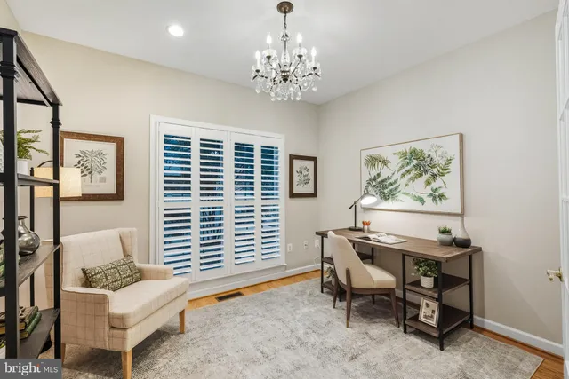 a living room with furniture a chandelier and a dining table