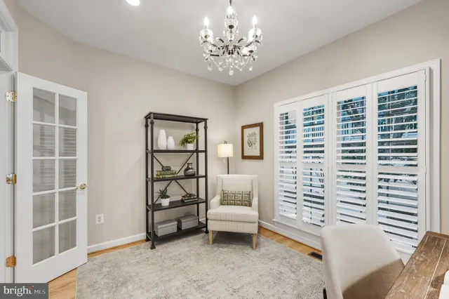 a living room with furniture a rug and a chandelier