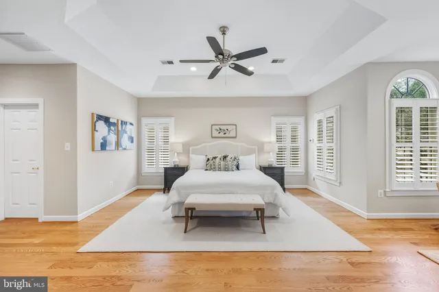a bedroom with a large bed and a chandelier