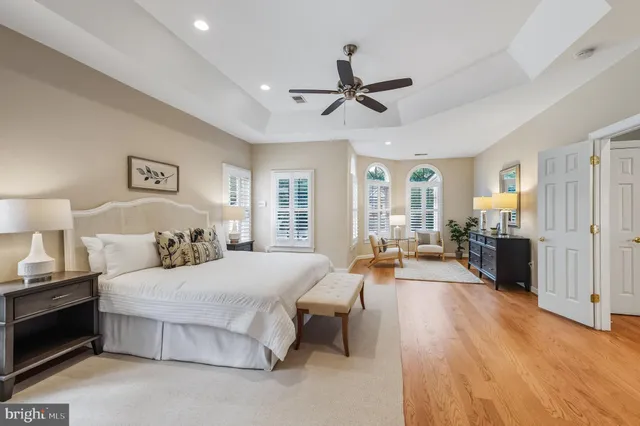 a spacious bathroom with a tub a sink and mirror