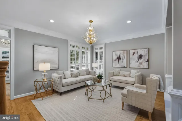 a living room with furniture a chandelier and a window