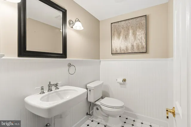 a view of backyard with large trees and wooden fence