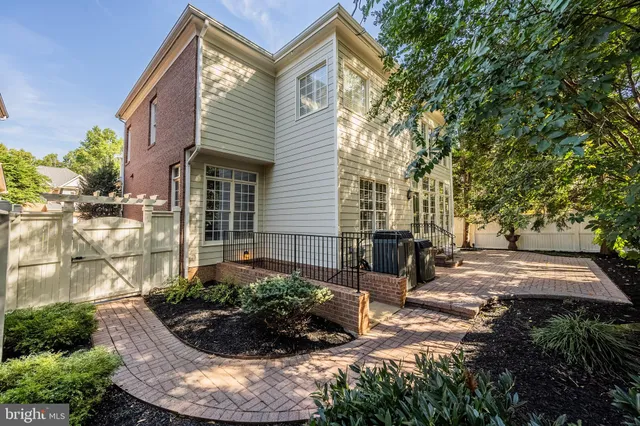 a front view of a house with a yard and potted plants