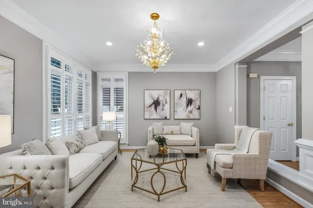 a living room with furniture flowerpot and window