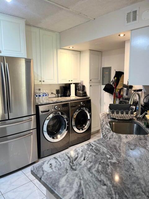 311 Pine Ridge Circle, Unit B1 Greenacres, FL 33463 - Photo 6 of 7 a kitchen with a refrigerator a stove a washer and dryer