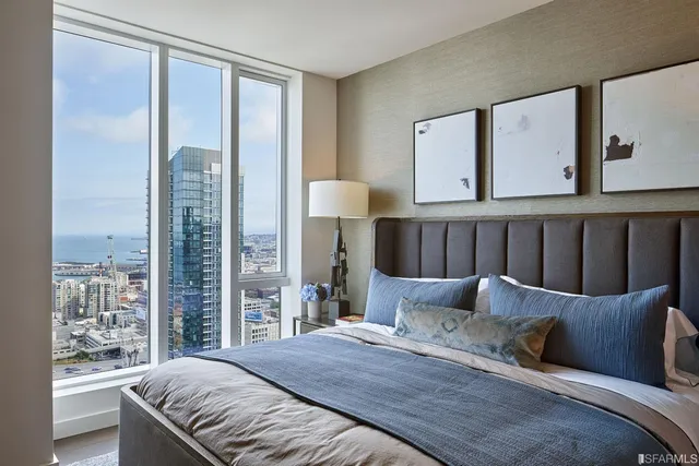 a bedroom with a large bed and a window