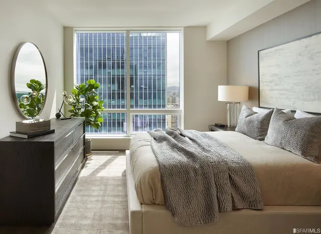 a bedroom with a bed and a large window