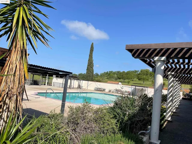 a view of a swimming pool with a patio