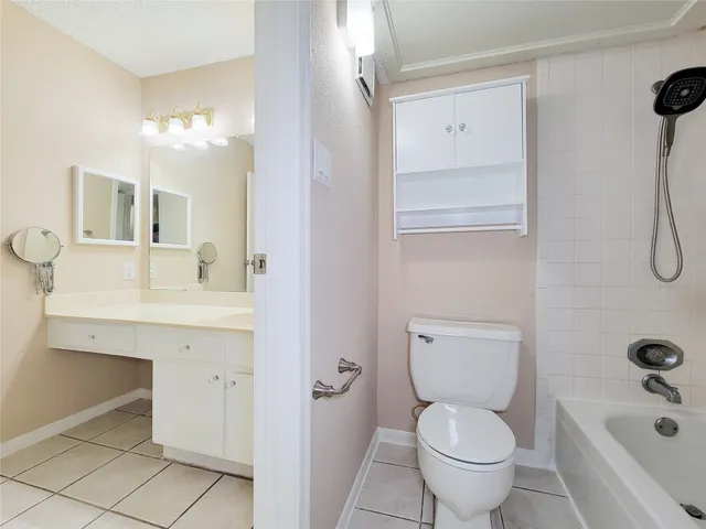 a view of an empty room and chandelier fan