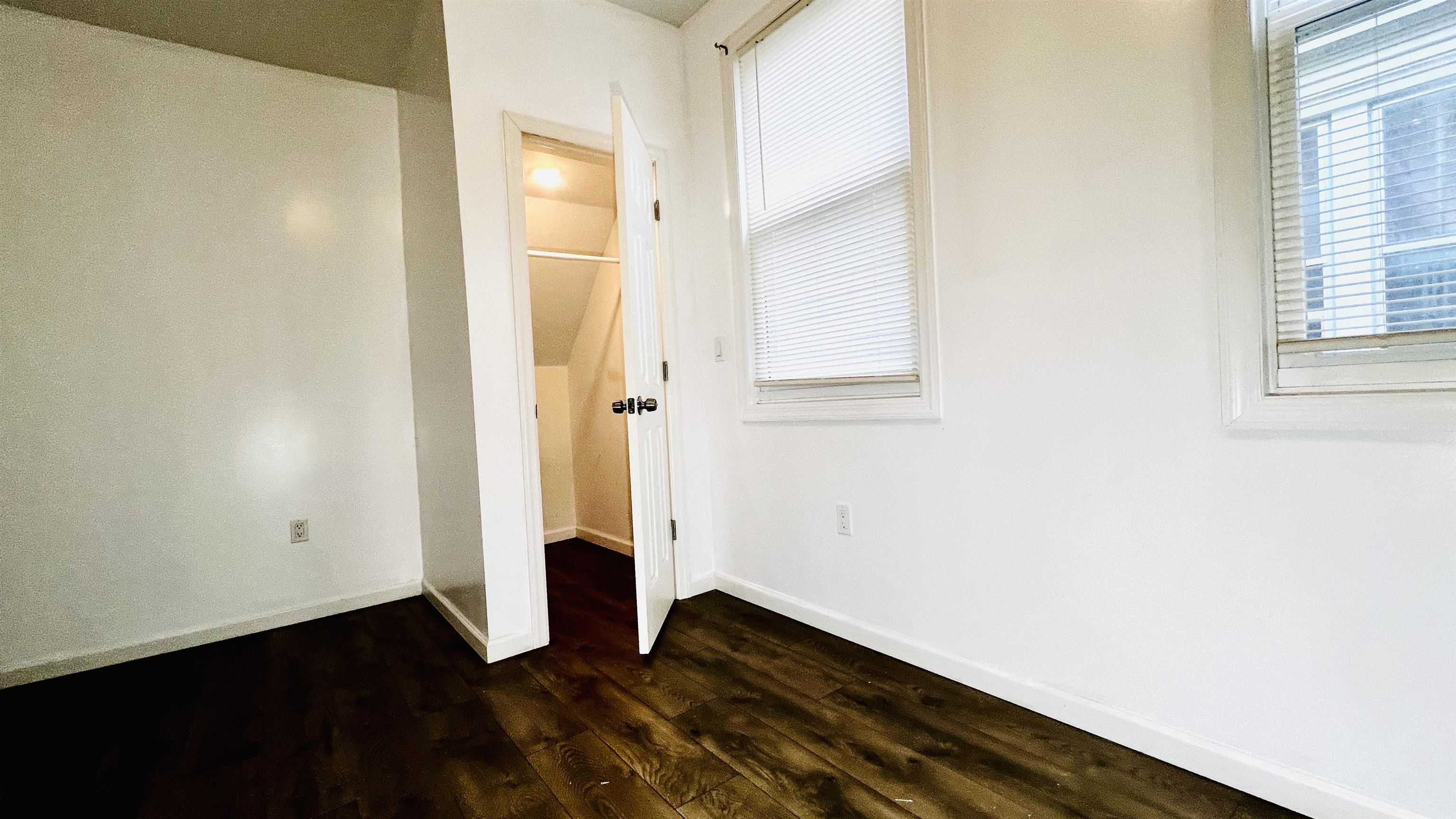 473 Grove Street, Unit 1 Irvington, NJ 07111 - Photo 2 of 9 an empty room with wooden floor