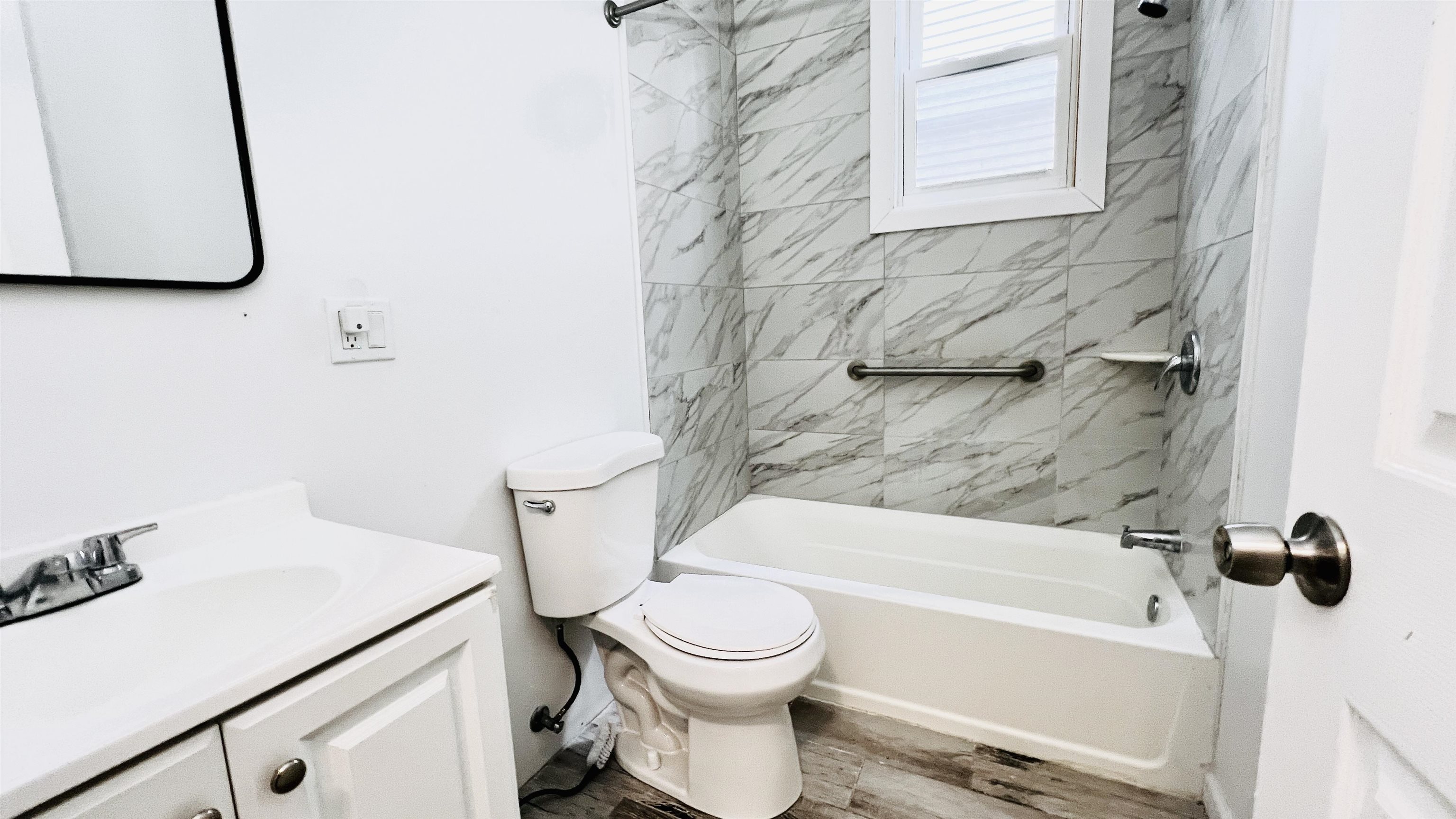 473 Grove Street, Unit 1 Irvington, NJ 07111 - Photo 9 of 9 a bathroom with a sink a toilet and a bathtub