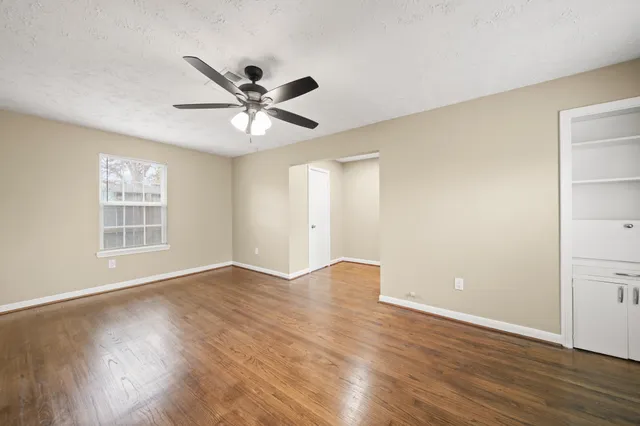 wooden floor in an empty room with a window