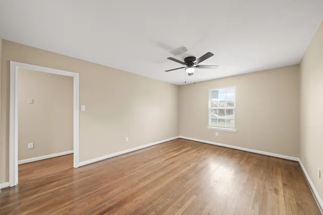 wooden floor in an empty room with a window