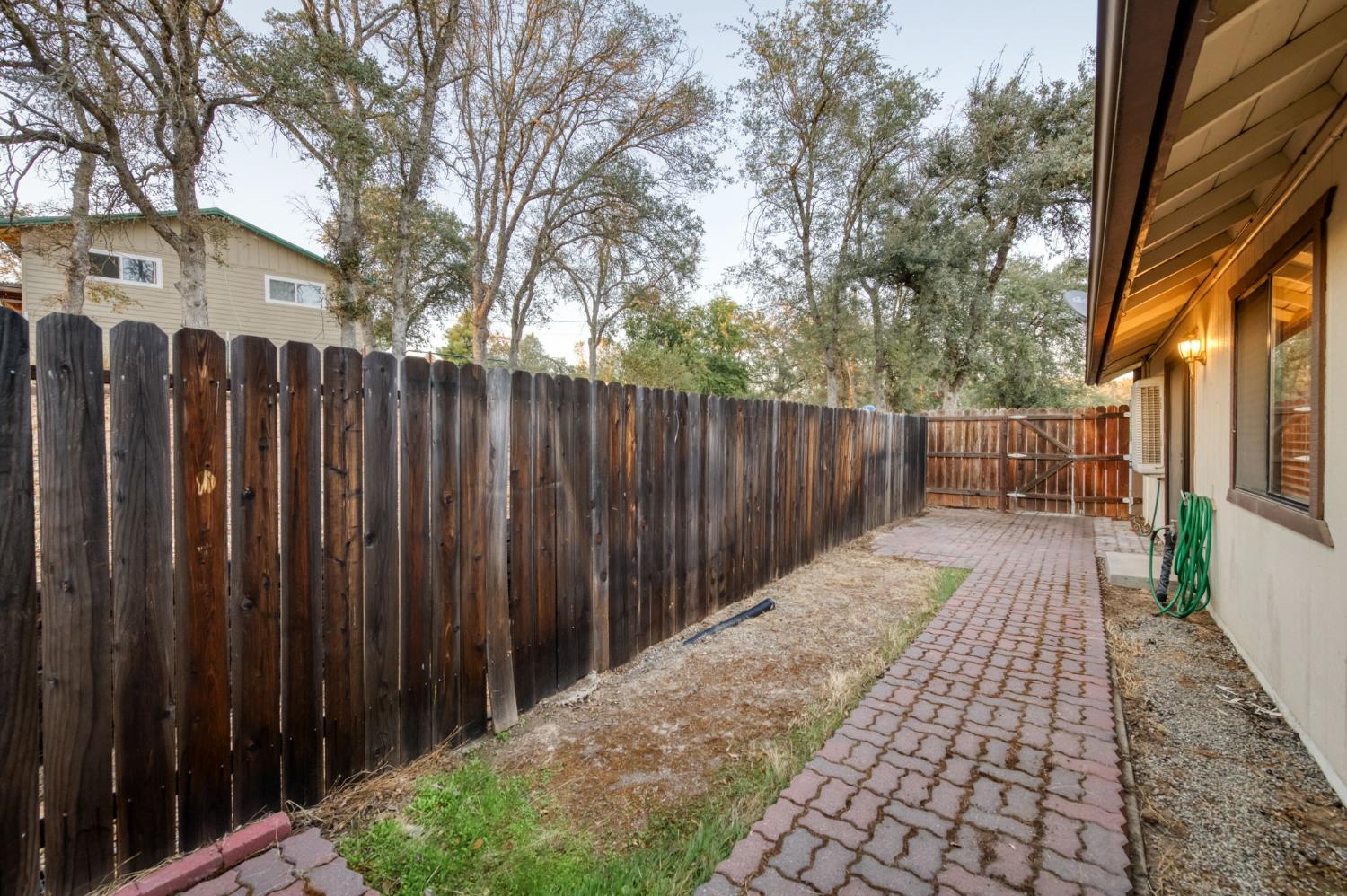 42607 Long Hollow Drive Coarsegold, CA 93614 - Photo 12 of 52 a view of a pathway with a wrought fence