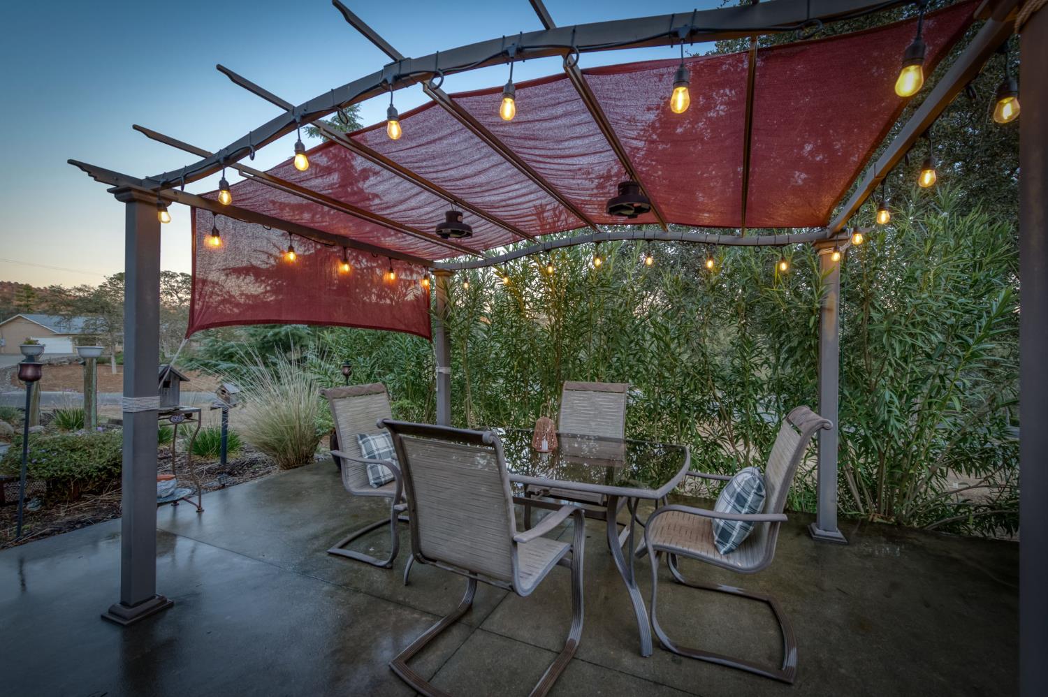 42607 Long Hollow Drive Coarsegold, CA 93614 - Photo 16 of 52 a patio with table and chairs with potted plants
