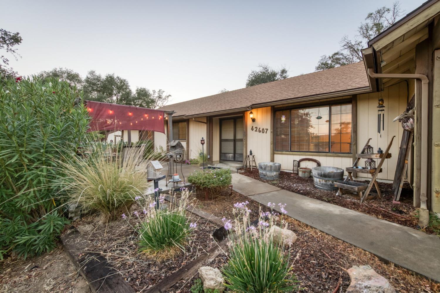 42607 Long Hollow Drive Coarsegold, CA 93614 - Photo 17 of 52 a front view of a house with garden