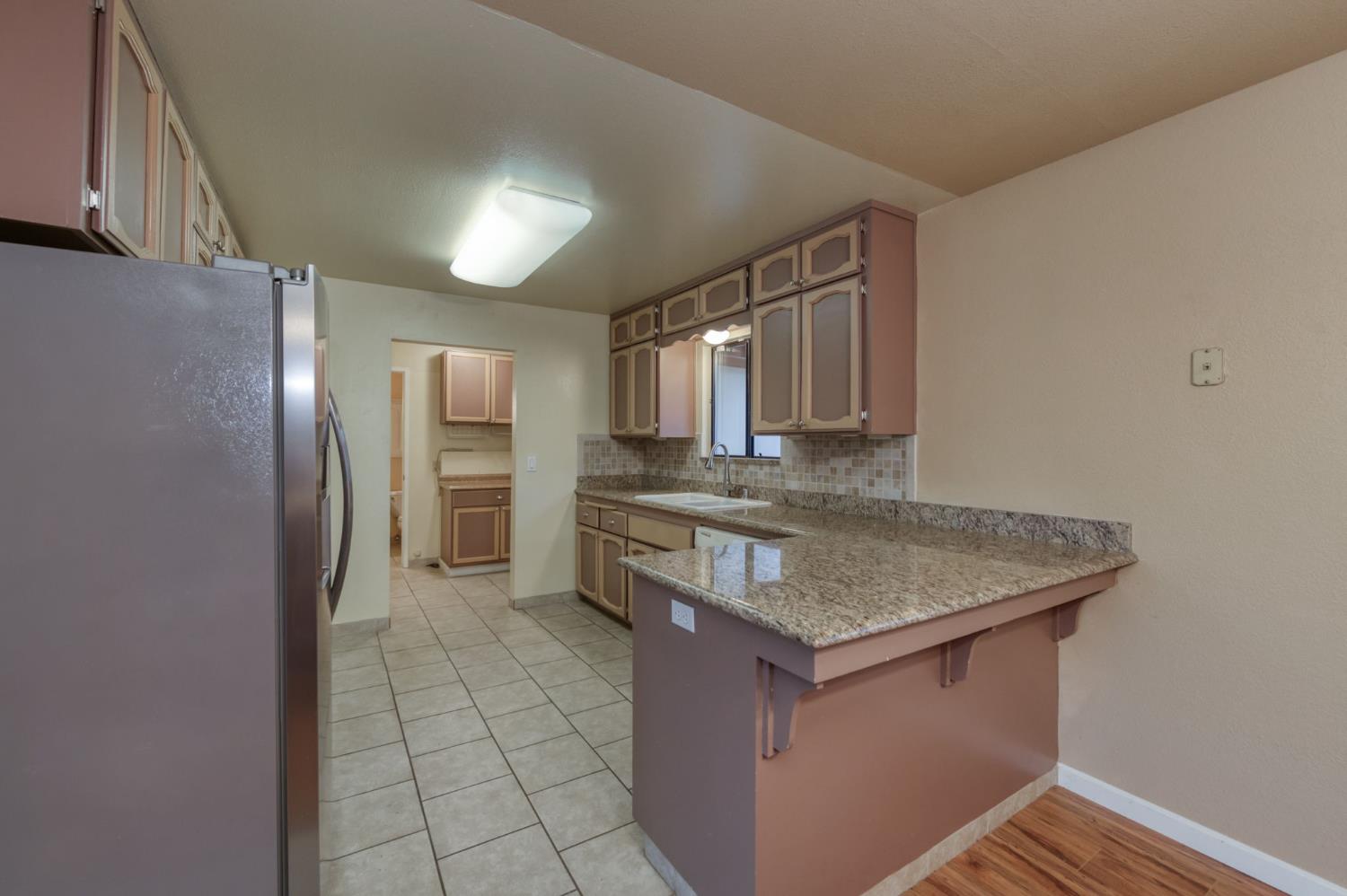42607 Long Hollow Drive Coarsegold, CA 93614 - Photo 24 of 52 a kitchen with stainless steel appliances granite countertop a sink and a refrigerator