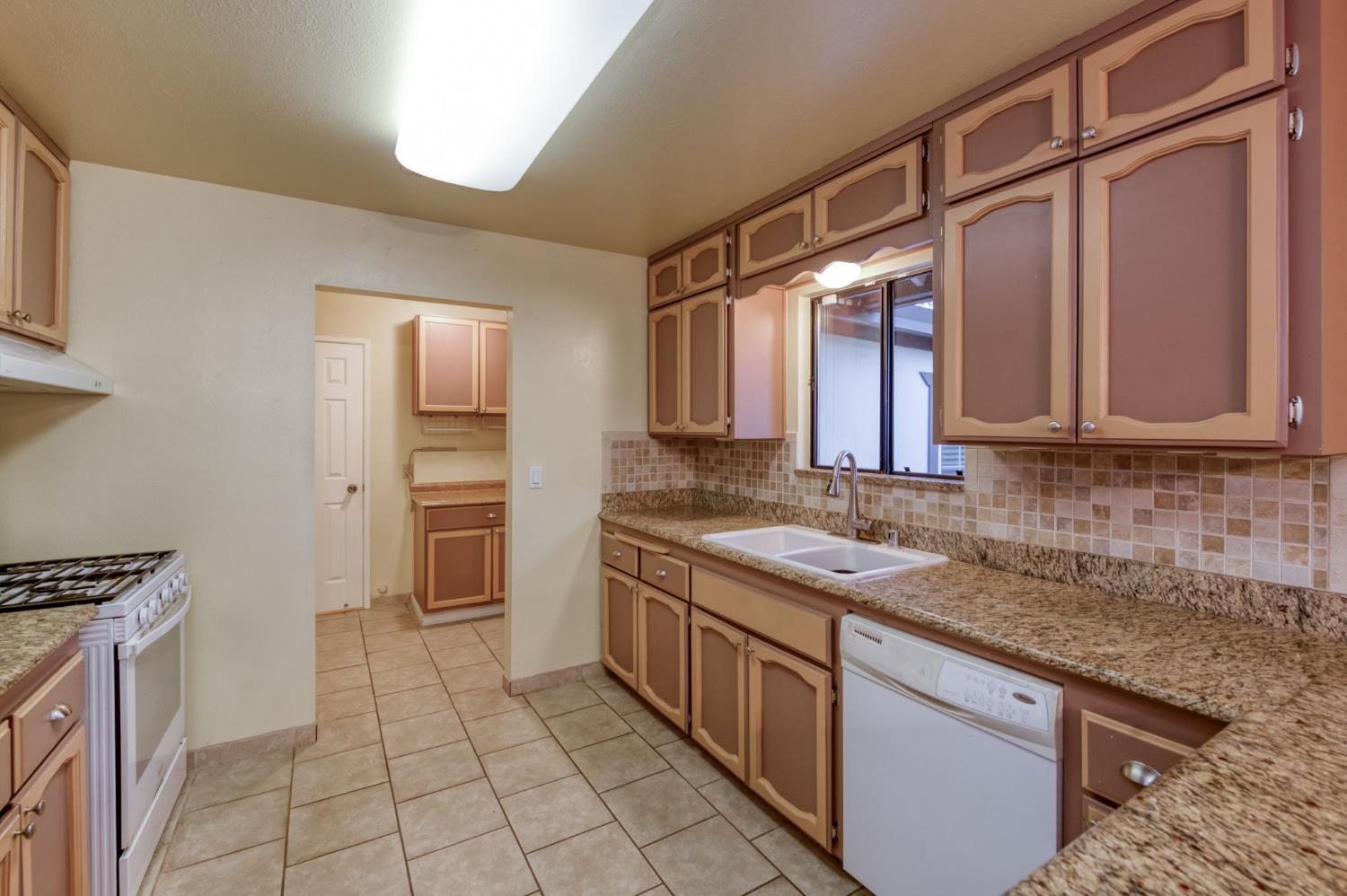 42607 Long Hollow Drive Coarsegold, CA 93614 - Photo 26 of 52 a kitchen with a sink stove and cabinets