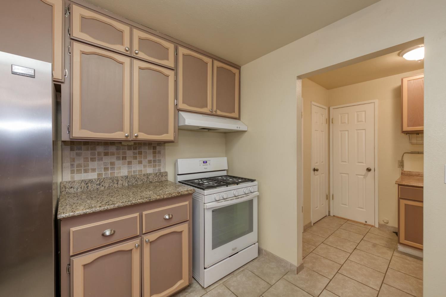 42607 Long Hollow Drive Coarsegold, CA 93614 - Photo 29 of 52 a kitchen with stainless steel appliances granite countertop a stove a sink and a refrigerator