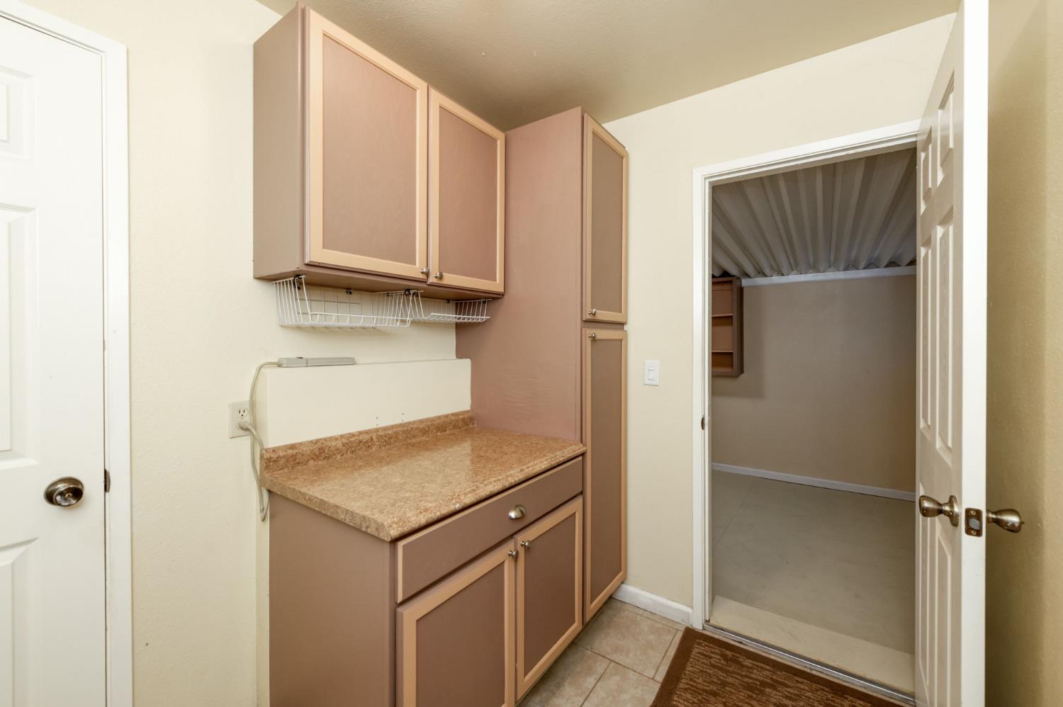 42607 Long Hollow Drive Coarsegold, CA 93614 - Photo 30 of 52 a kitchen with a refrigerator and cabinets