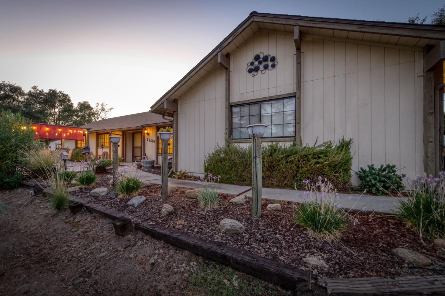 42607 Long Hollow Drive Coarsegold, CA 93614 - Photo 37 of 52 a backyard of a house with plants and barbeque oven