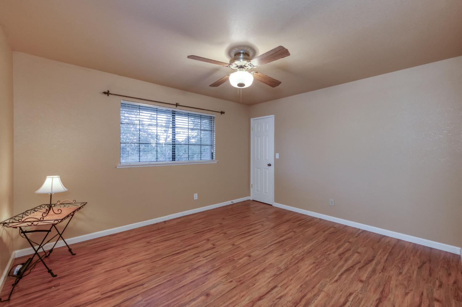 42607 Long Hollow Drive Coarsegold, CA 93614 - Photo 5 of 52 a view of an empty room with wooden floor and a window